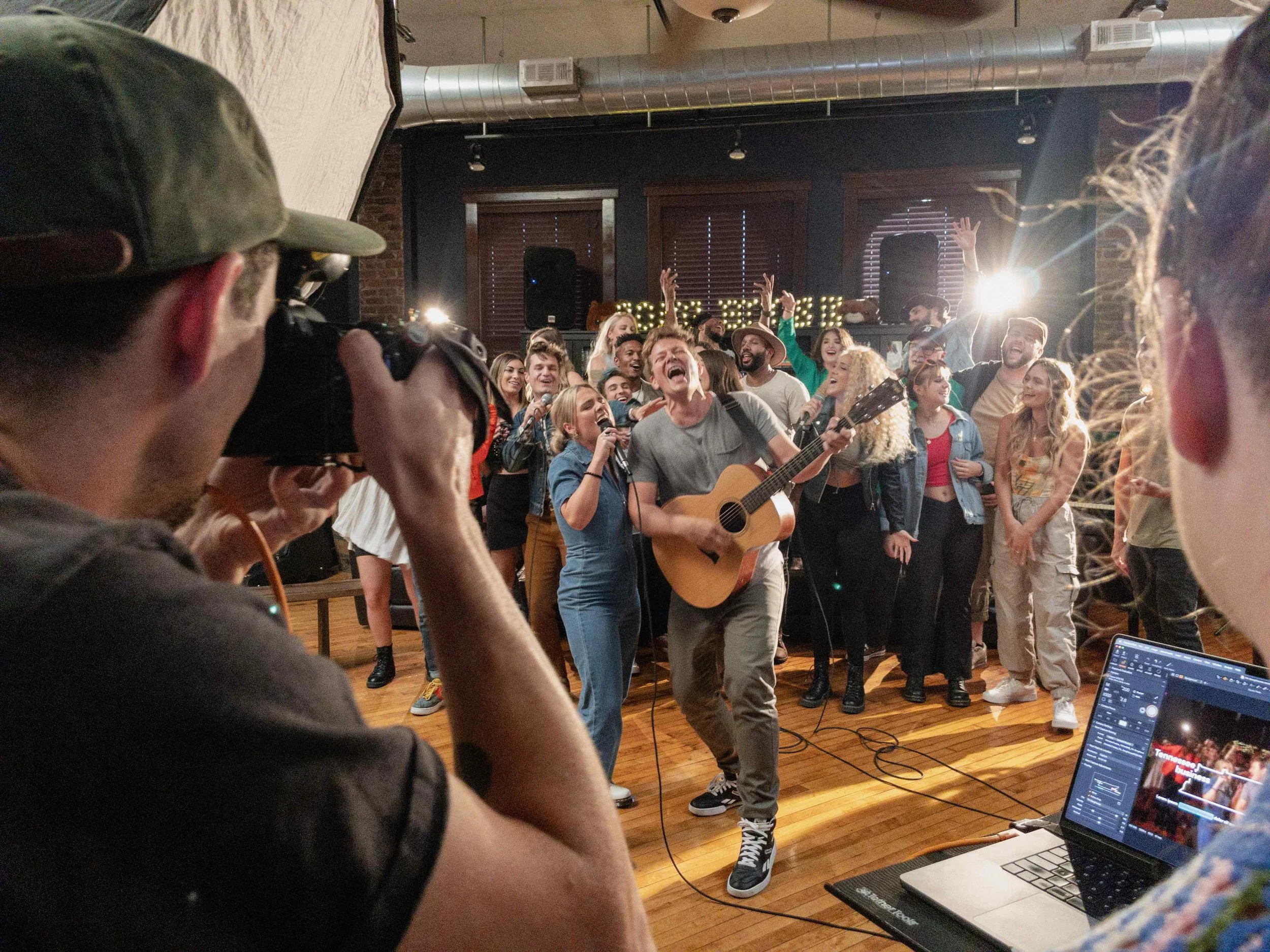 Song House artists singing together while being filmed